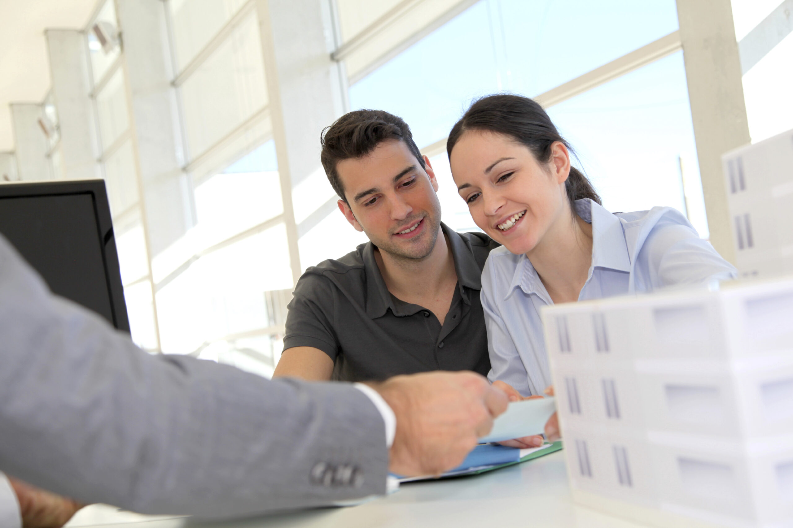 Couple being given advice at a desk