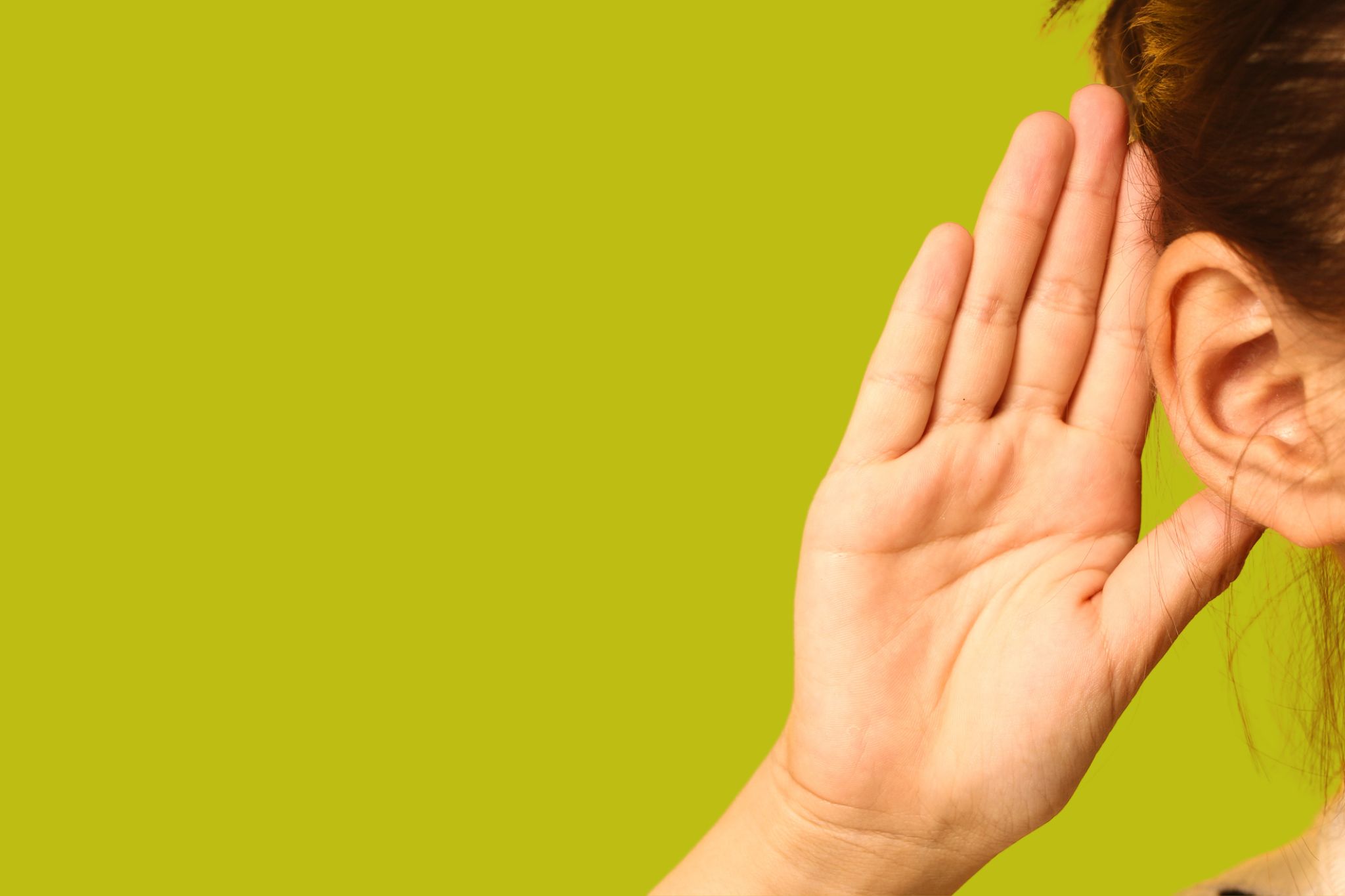 close up of hand behind ear